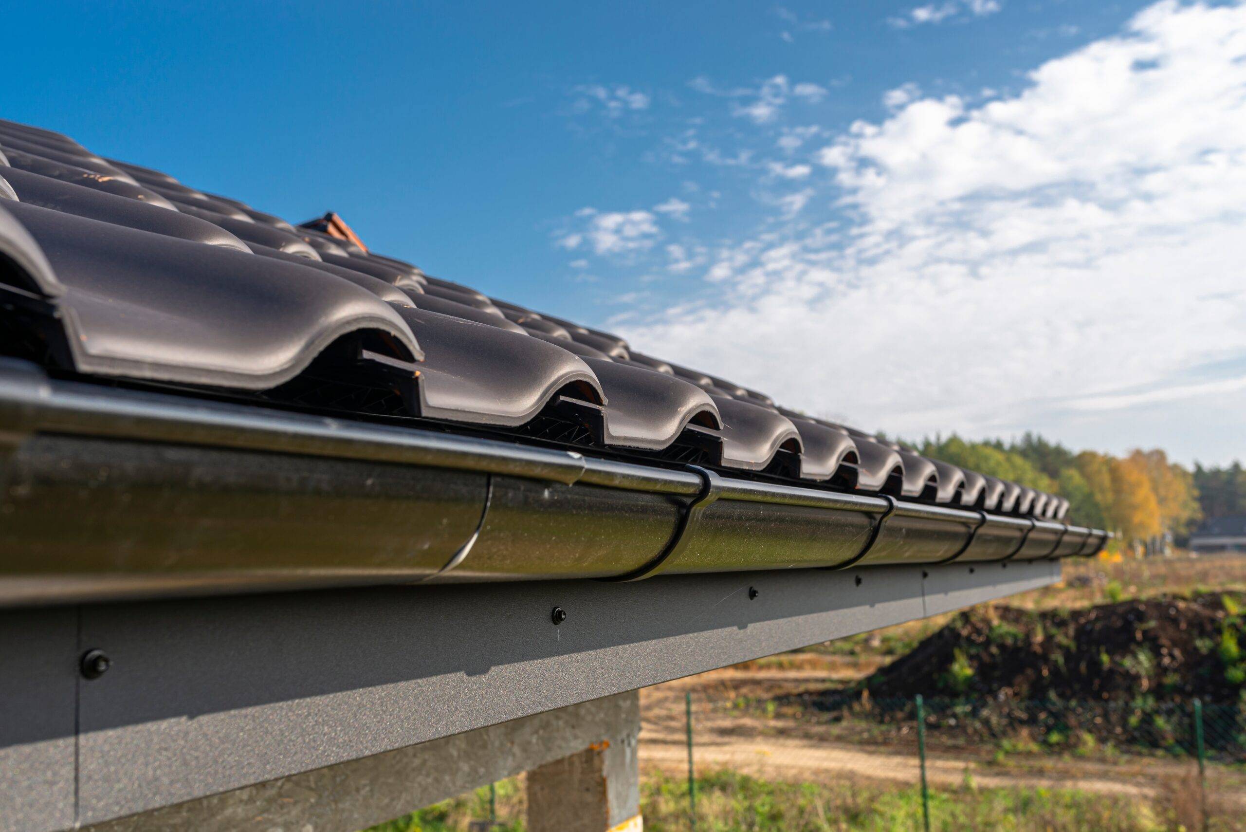 a metal black gutter on a roof covered with ceram 2025 03 12 21 49 17 utc scaled