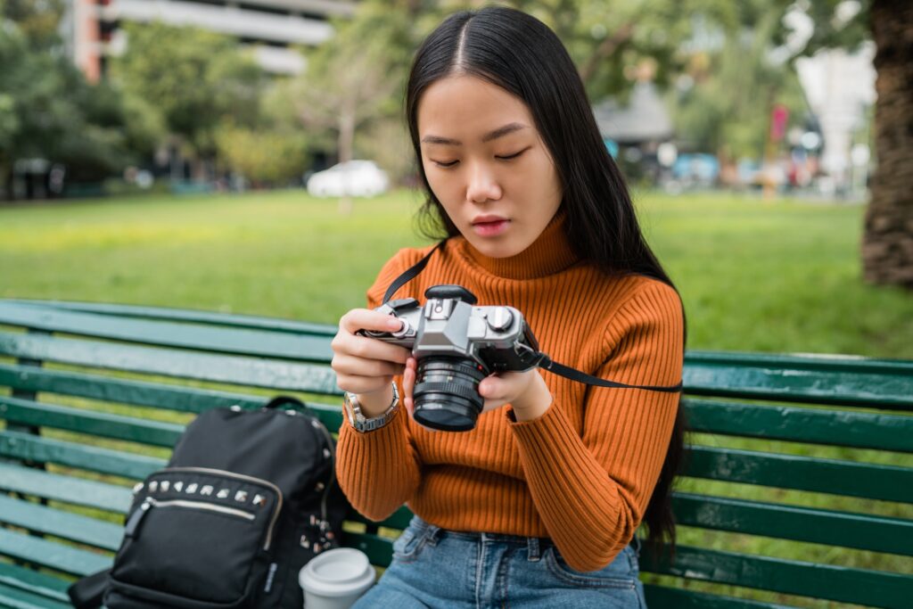 asian woman using a professional camera