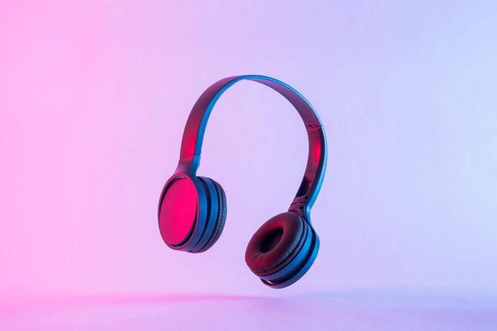 contemporary headphones in neon night lighting at a party and modern stereo music technology