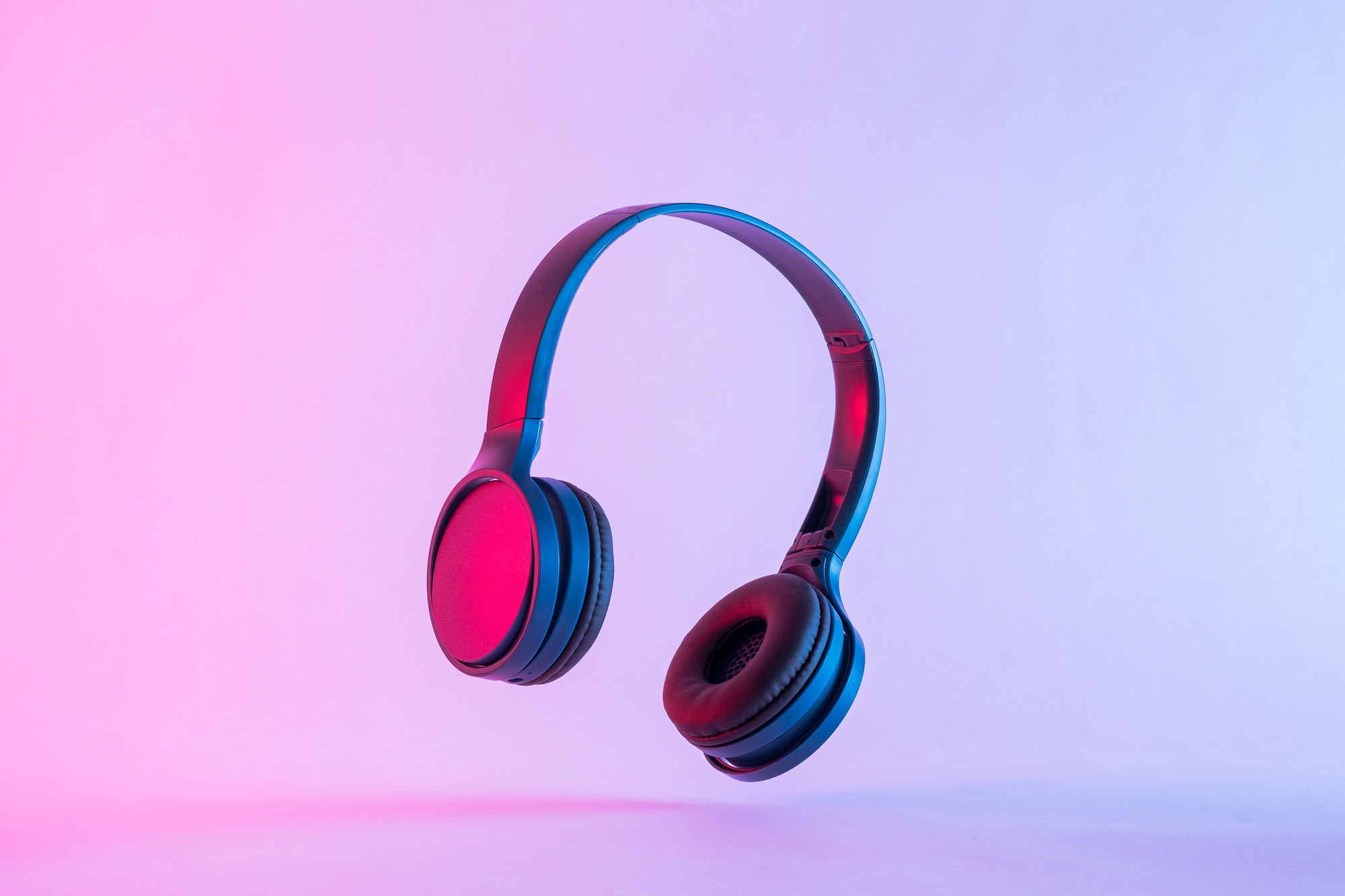 contemporary headphones in neon night lighting at a party and modern stereo music technology