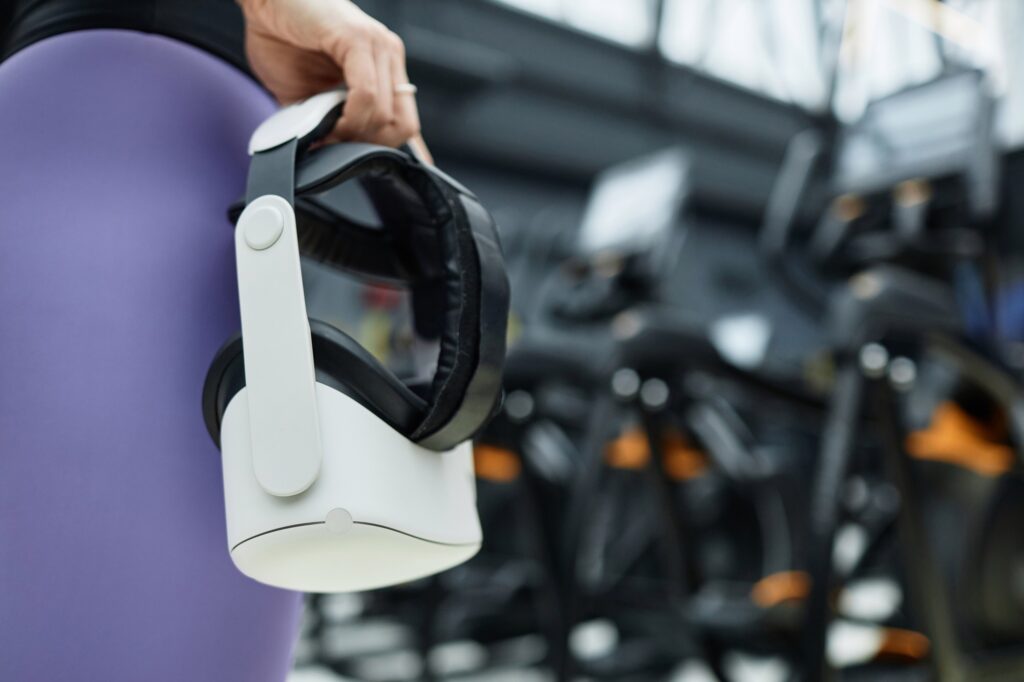 hand holding vr headset in gym