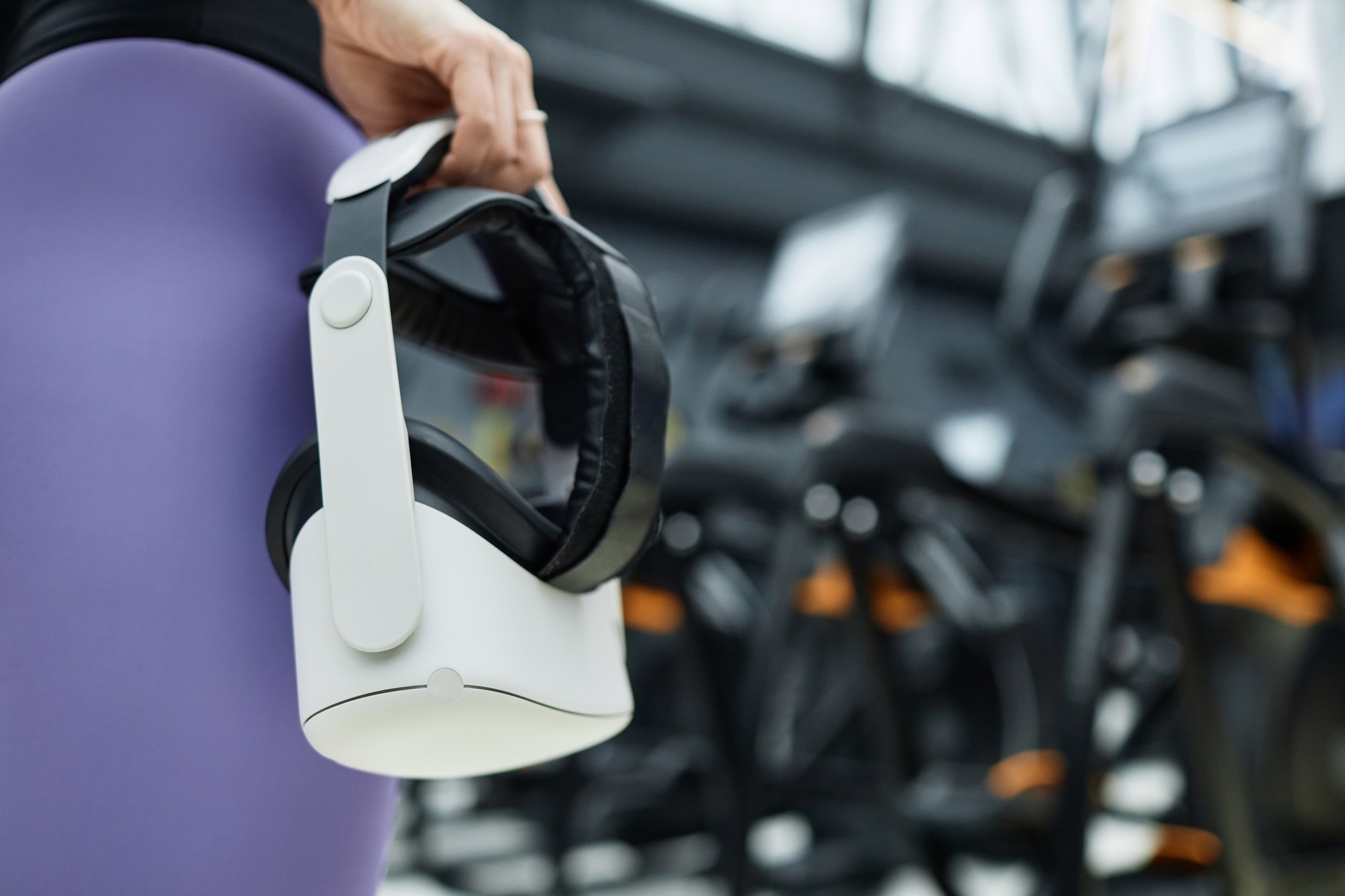 hand holding vr headset in gym