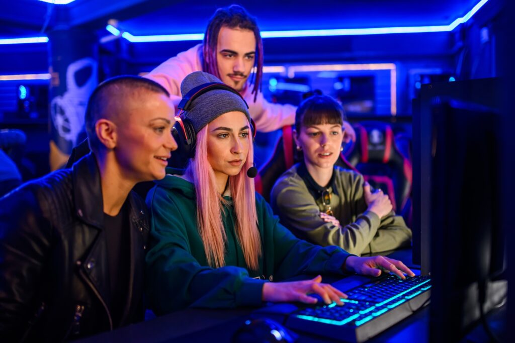 multiracial team of professional gamers playing video games in a gaming club