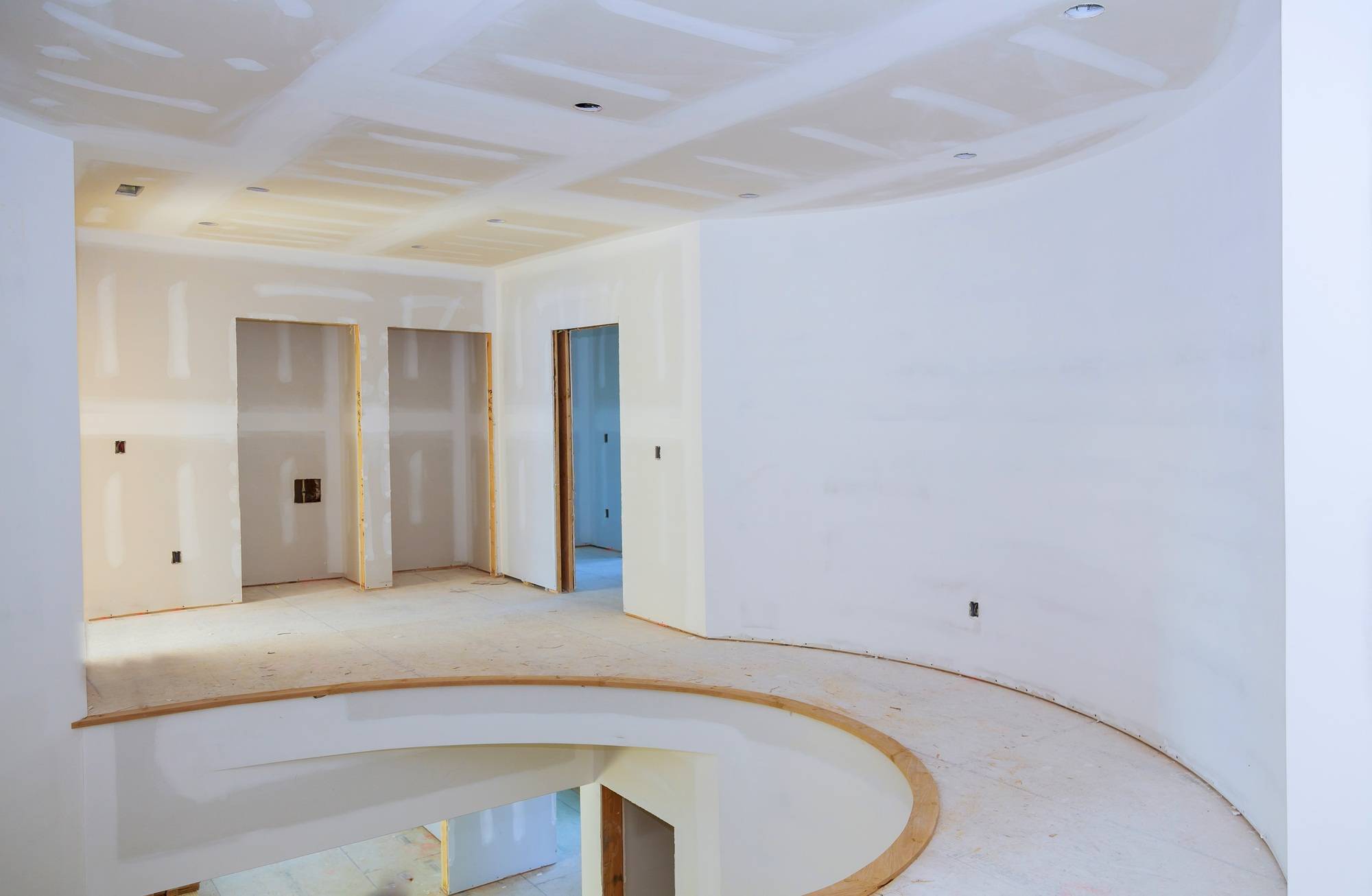 walls of interior construction of housing project with drywall installed and patched without